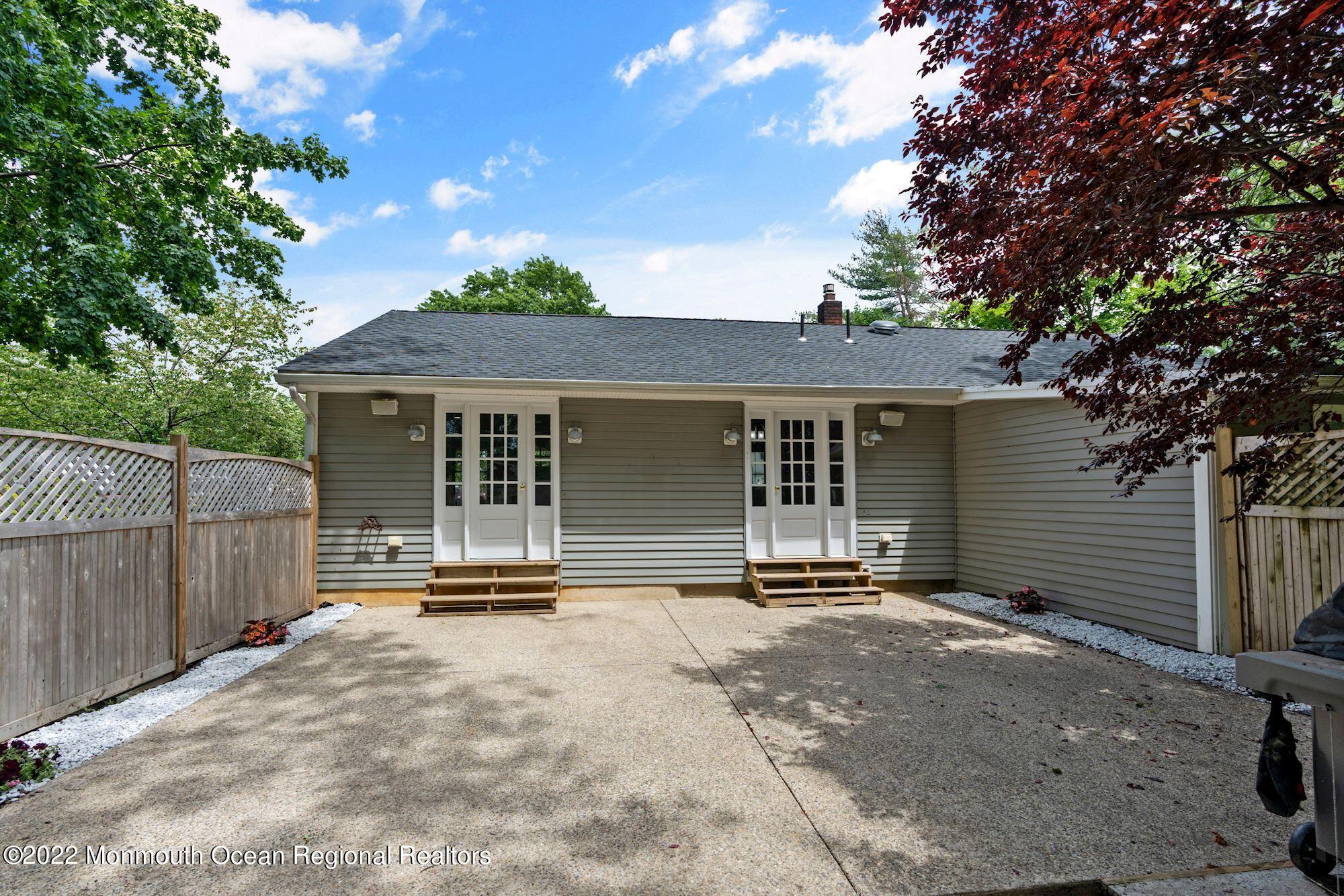 738 Holmdel Road Holmdel, NJ 07733 - Photo 5 of 36 a front view of a house with a garden