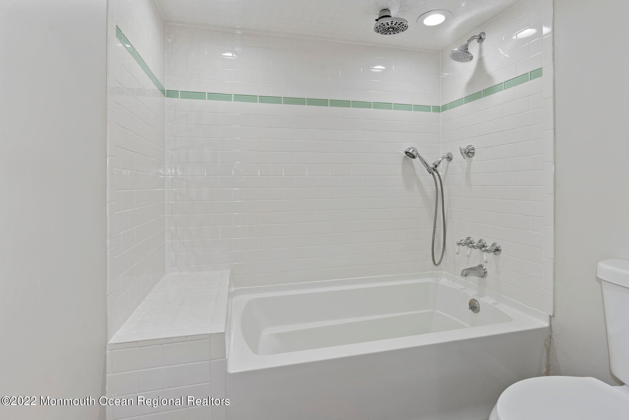 738 Holmdel Road Holmdel, NJ 07733 - Photo 10 of 36 a bathroom with a bathtub and a shower