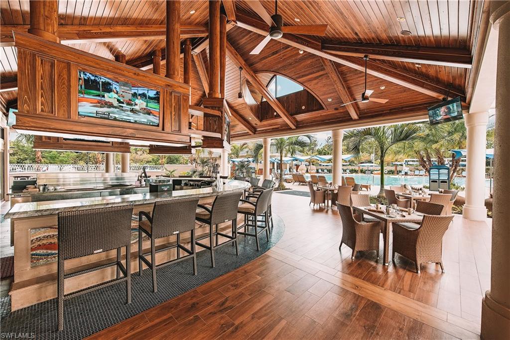 2220 Residence Circle Naples, FL 34105 - Photo 49 of 50 a outdoor space with lots of tables a chairs and chandelier