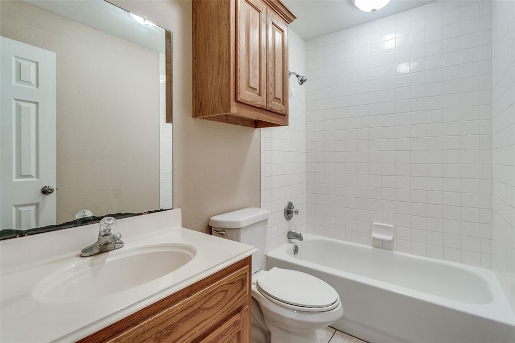 454 East Fulton Street Van Alstyne, TX 75495 - Photo 18 of 25 a bathroom with a sink a toilet and bathtub