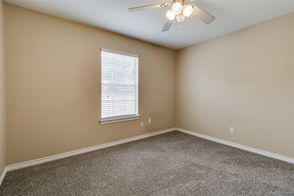 454 East Fulton Street Van Alstyne, TX 75495 - Photo 23 of 25 an empty room with a chandelier fan and window