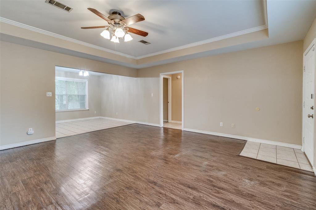 454 East Fulton Street Van Alstyne, TX 75495 - Photo 3 of 25 wooden floor in an empty room with a window