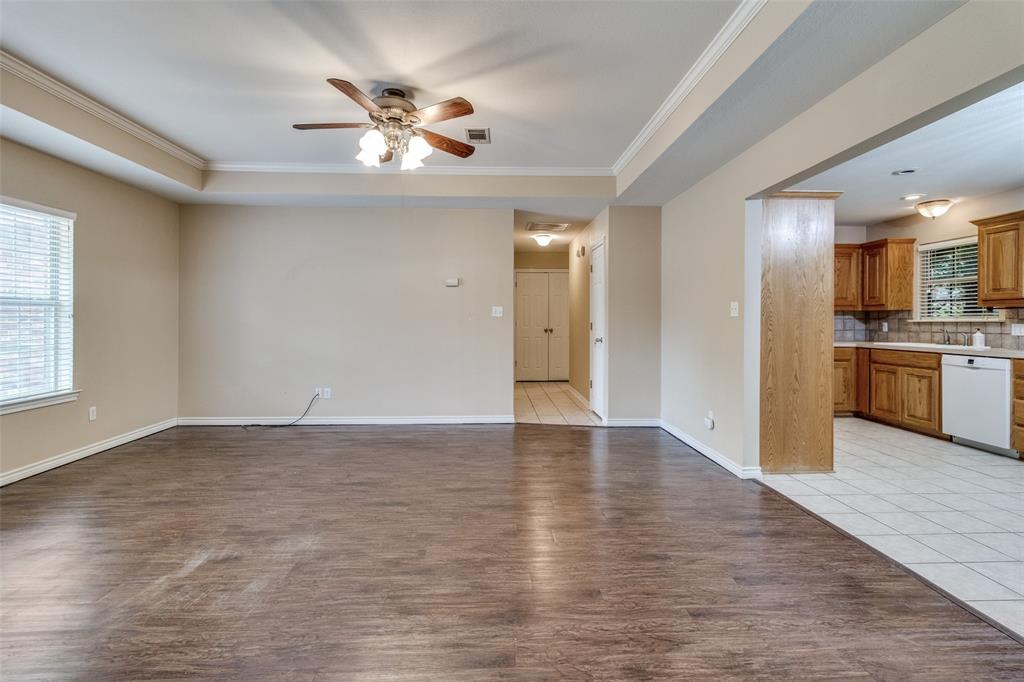 454 East Fulton Street Van Alstyne, TX 75495 - Photo 6 of 25 a view of an empty room with a kitchen