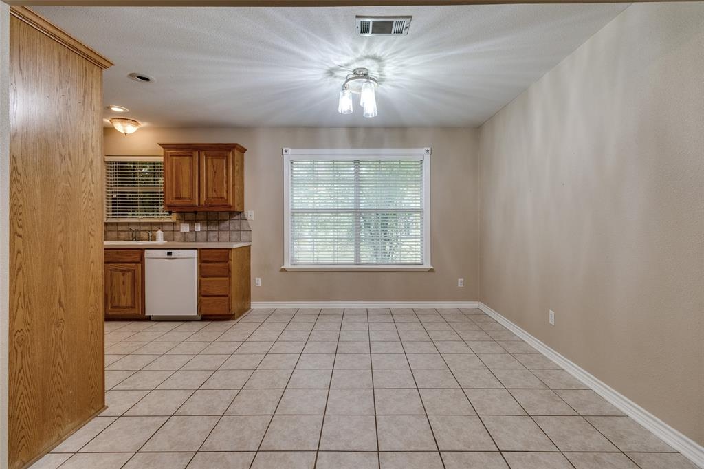 454 East Fulton Street Van Alstyne, TX 75495 - Photo 8 of 25 a kitchen with a stove a sink and a refrigerator