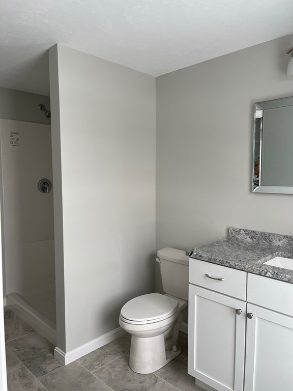 30 Markham Circle Ayer, MA 01432 - Photo 12 of 22 a white toilet sitting next to a bathroom sink