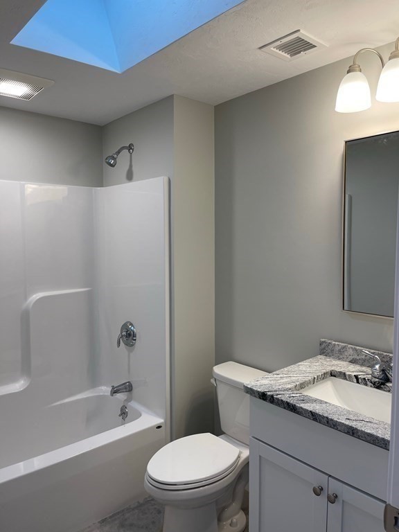 30 Markham Circle Ayer, MA 01432 - Photo 15 of 22 a bathroom with a granite countertop toilet a sink and a bathtub