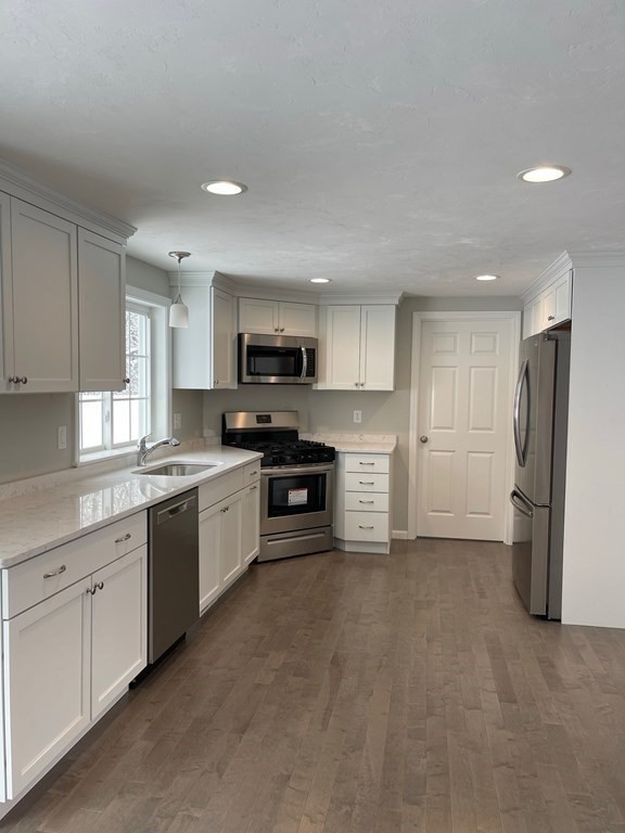 30 Markham Circle Ayer, MA 01432 - Photo 2 of 22 a kitchen with stainless steel appliances granite countertop a refrigerator and a stove top oven
