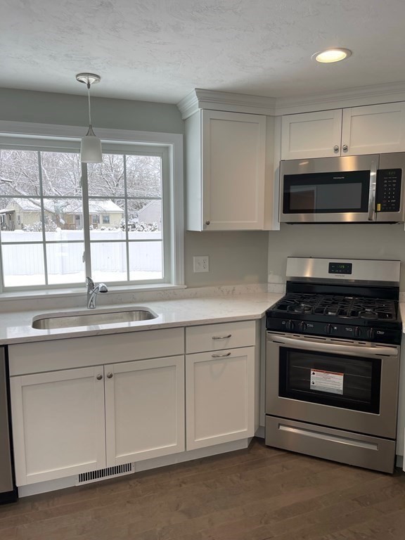 30 Markham Circle Ayer, MA 01432 - Photo 3 of 22 a kitchen with granite countertop a stove and a sink