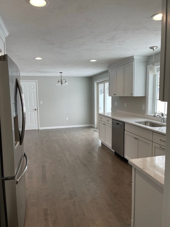 30 Markham Circle Ayer, MA 01432 - Photo 4 of 22 a kitchen with stainless steel appliances granite countertop a refrigerator and a sink