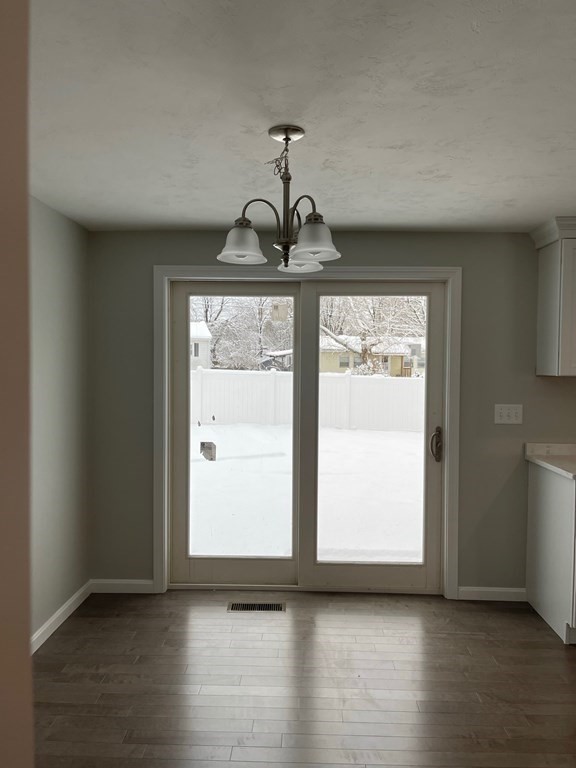 30 Markham Circle Ayer, MA 01432 - Photo 5 of 22 a view of an empty room with wooden floor and a window