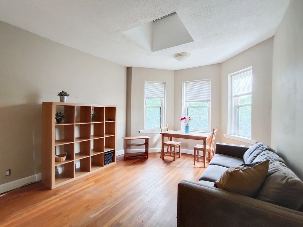 a living room with furniture window and wooden floor