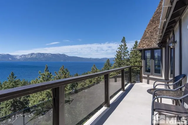 a view of a balcony with a table and chairs