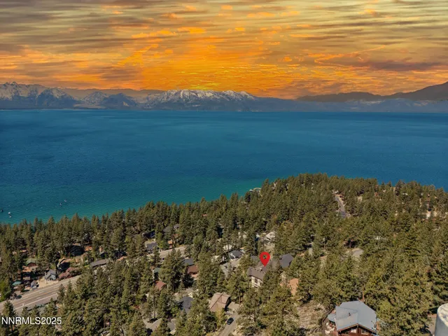 an aerial view of a house with swimming pool and mountain view