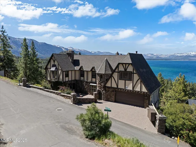 an aerial view of a house with lake view
