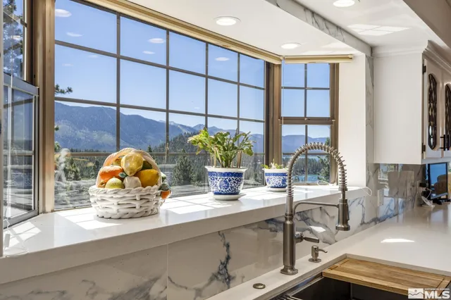 a living room with lots of furniture and a large window