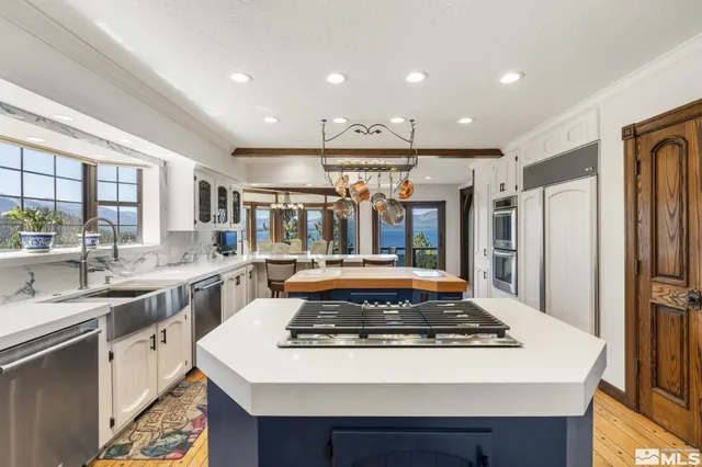 a view of a dining room with furniture large windows and wooden floor