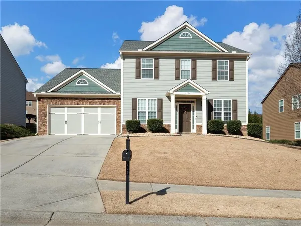 a front view of a house with yard