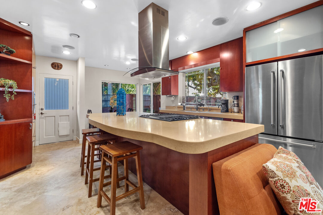5008 Valley Ridge Avenue View Park, CA 90043 - Photo 11 of 28 a kitchen with stainless steel appliances granite countertop a sink and a refrigerator