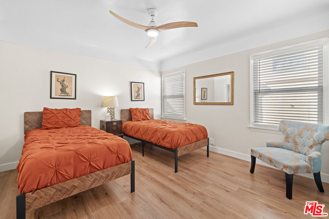 5008 Valley Ridge Avenue View Park, CA 90043 - Photo 14 of 28 a bedroom with two beds and a chair