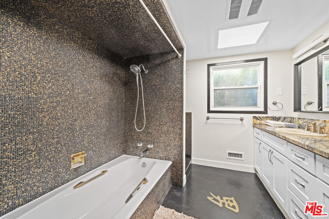 5008 Valley Ridge Avenue View Park, CA 90043 - Photo 16 of 28 a bathroom with a granite countertop sink a toilet and bathtub