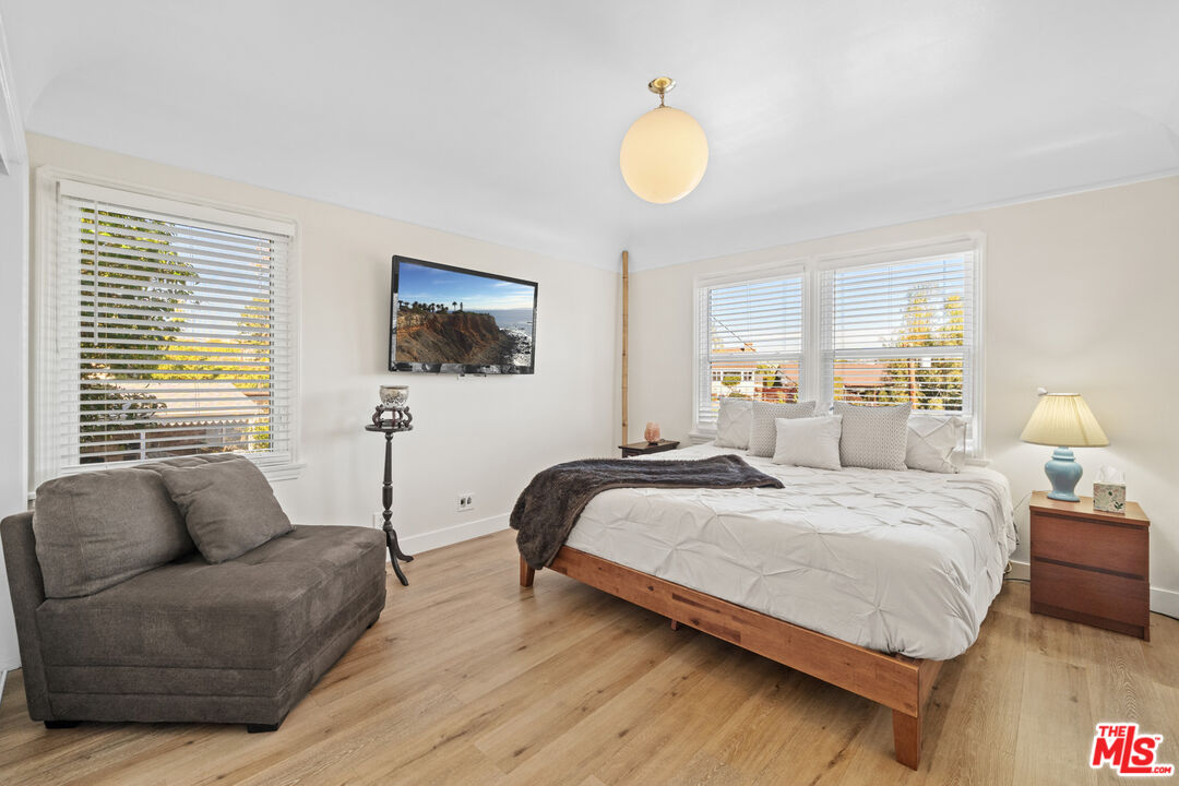 5008 Valley Ridge Avenue View Park, CA 90043 - Photo 17 of 28 a bedroom with a bed couch and window
