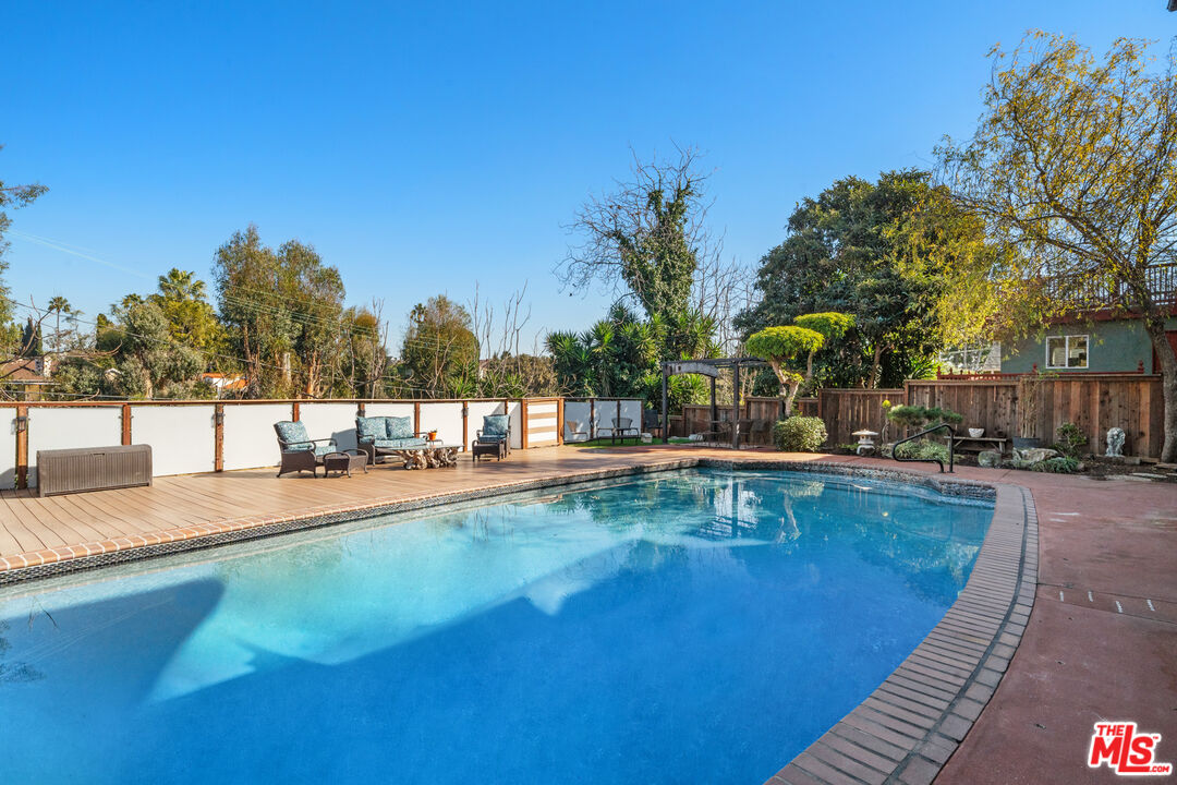 5008 Valley Ridge Avenue View Park, CA 90043 - Photo 24 of 28 a view of a swimming pool with chairs