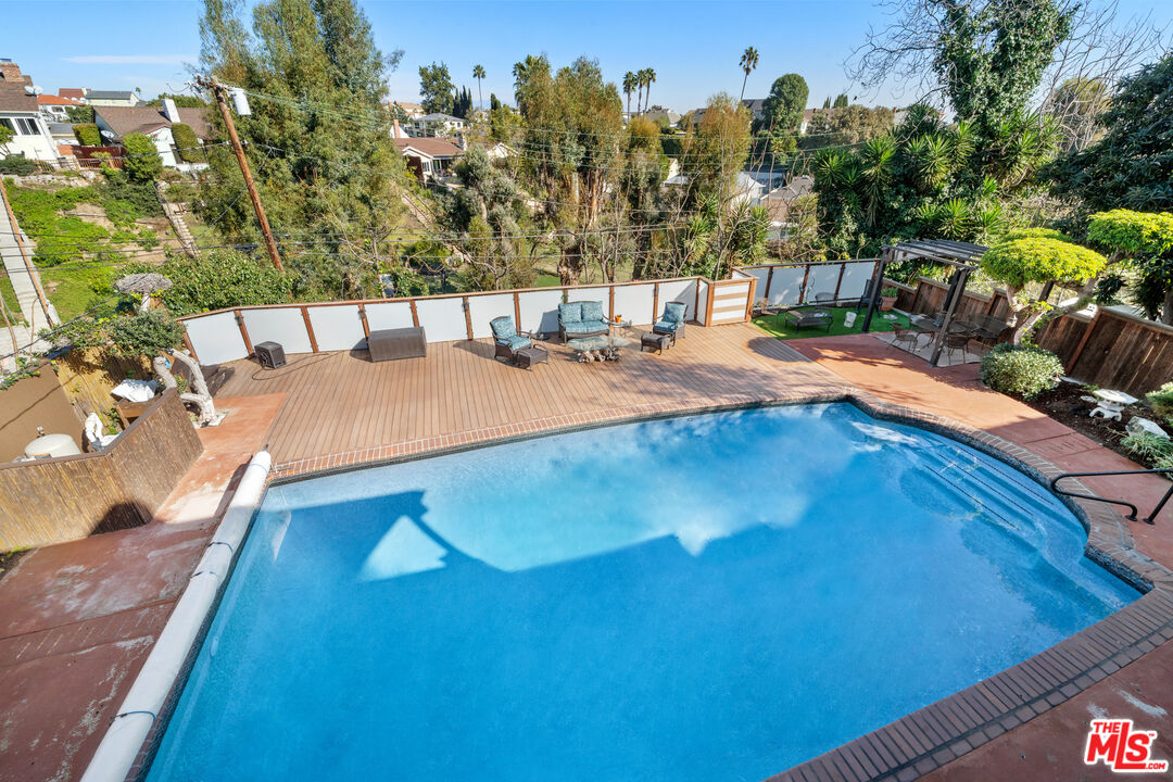 5008 Valley Ridge Avenue View Park, CA 90043 - Photo 25 of 28 a view of a swimming pool with an outdoor space and seating area
