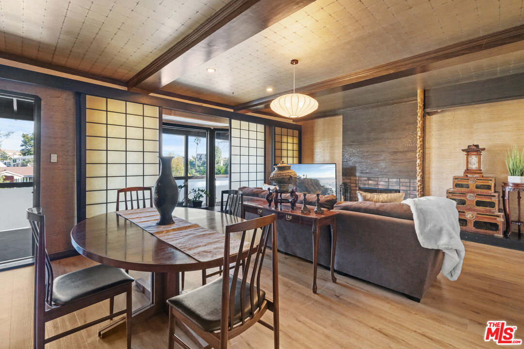 5008 Valley Ridge Avenue View Park, CA 90043 - Photo 7 of 28 a view of a dining room with furniture window and wooden floor