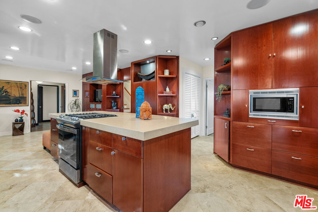 5008 Valley Ridge Avenue View Park, CA 90043 - Photo 10 of 28 a kitchen with stainless steel appliances granite countertop a stove and a refrigerator