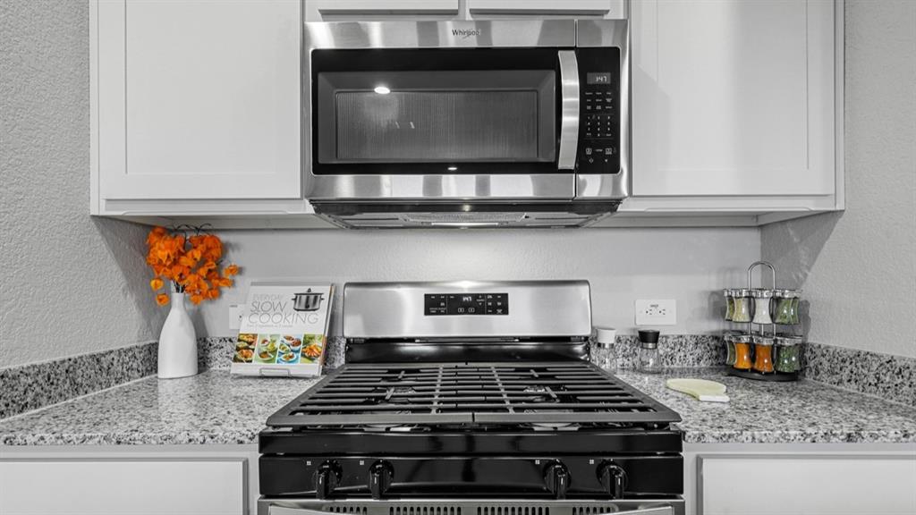 16417 Rangerville Drive Justin, TX 76247 - Photo 4 of 39 a stove top oven sitting inside of a kitchen