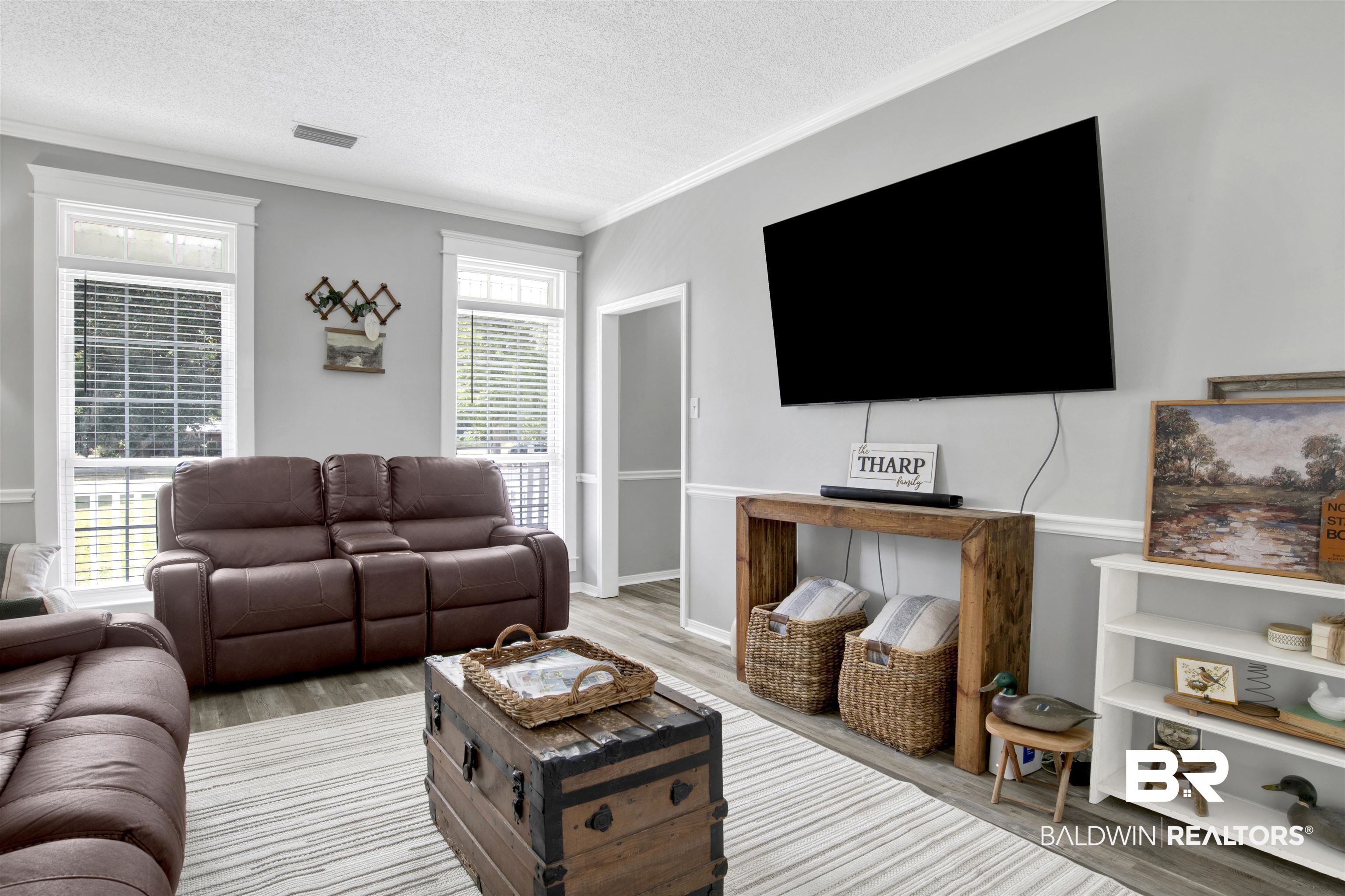 25700 Austin Road Daphne, AL 36526 - Photo 5 of 36 Living area featuring a textured ceiling, ornamental molding, and wood finished floors