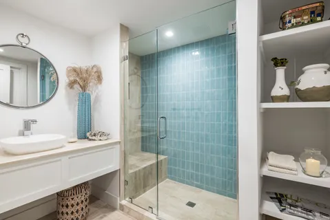 a bathroom with a double vanity sink mirror and shower