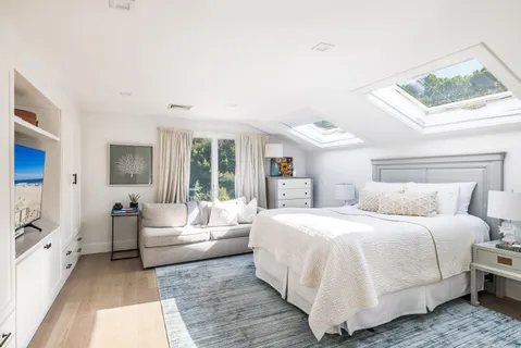 a bedroom with a large bed and a couch