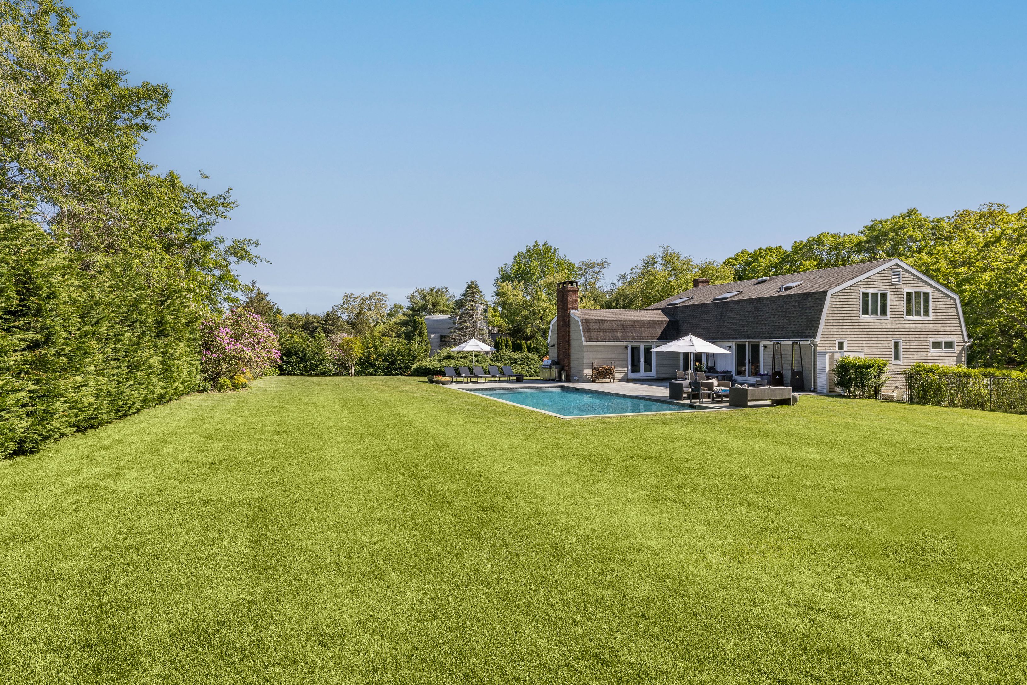 254 Water Mill Water Mill, NY 11976 - Photo 2 of 15 a view of a house with a big yard potted plants and large tree
