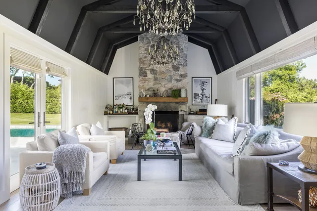 a living room with furniture a fireplace and a large window