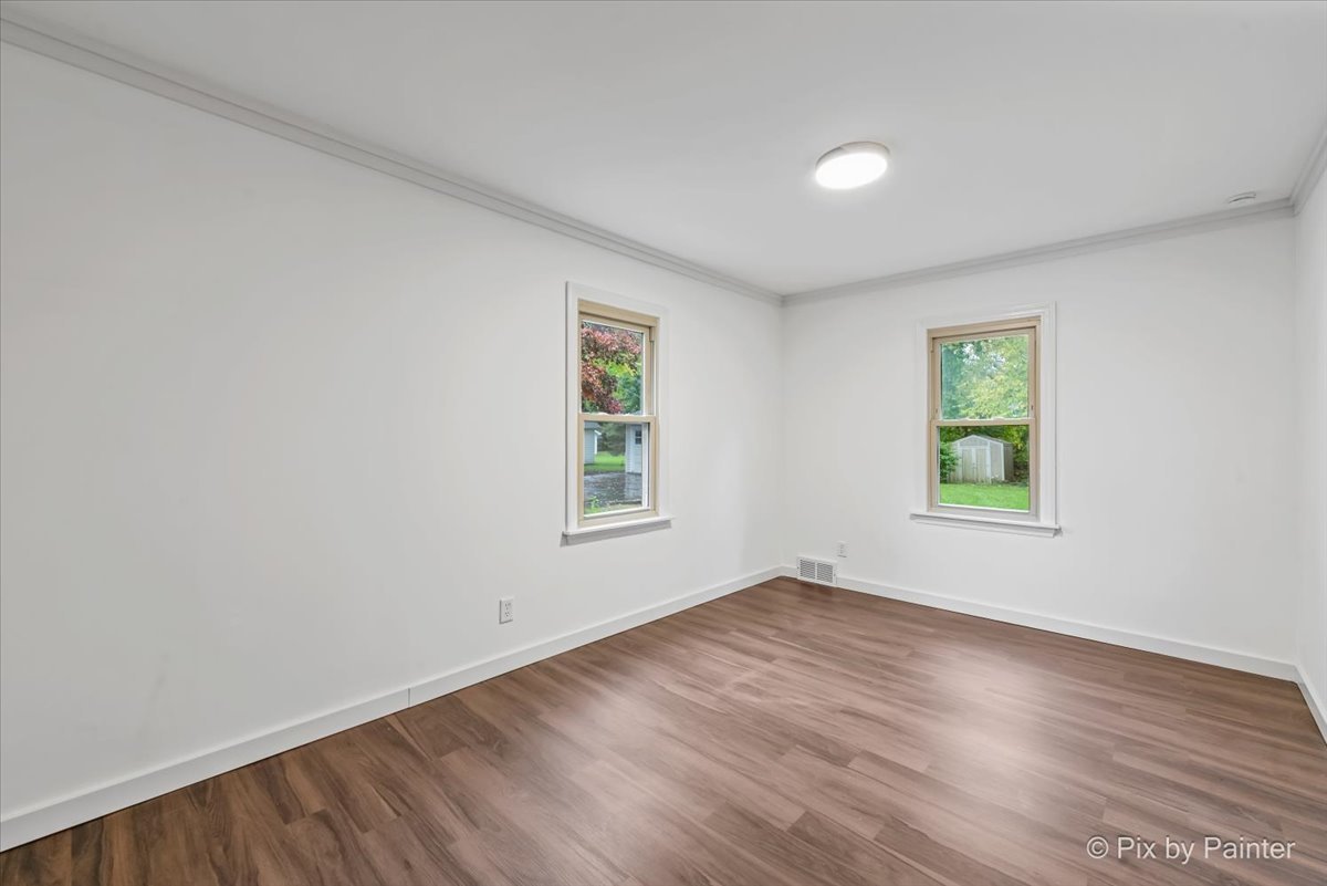 3019 Lincoln Road McHenry, IL 60051 - Photo 17 of 28 an empty room with wooden floor and windows