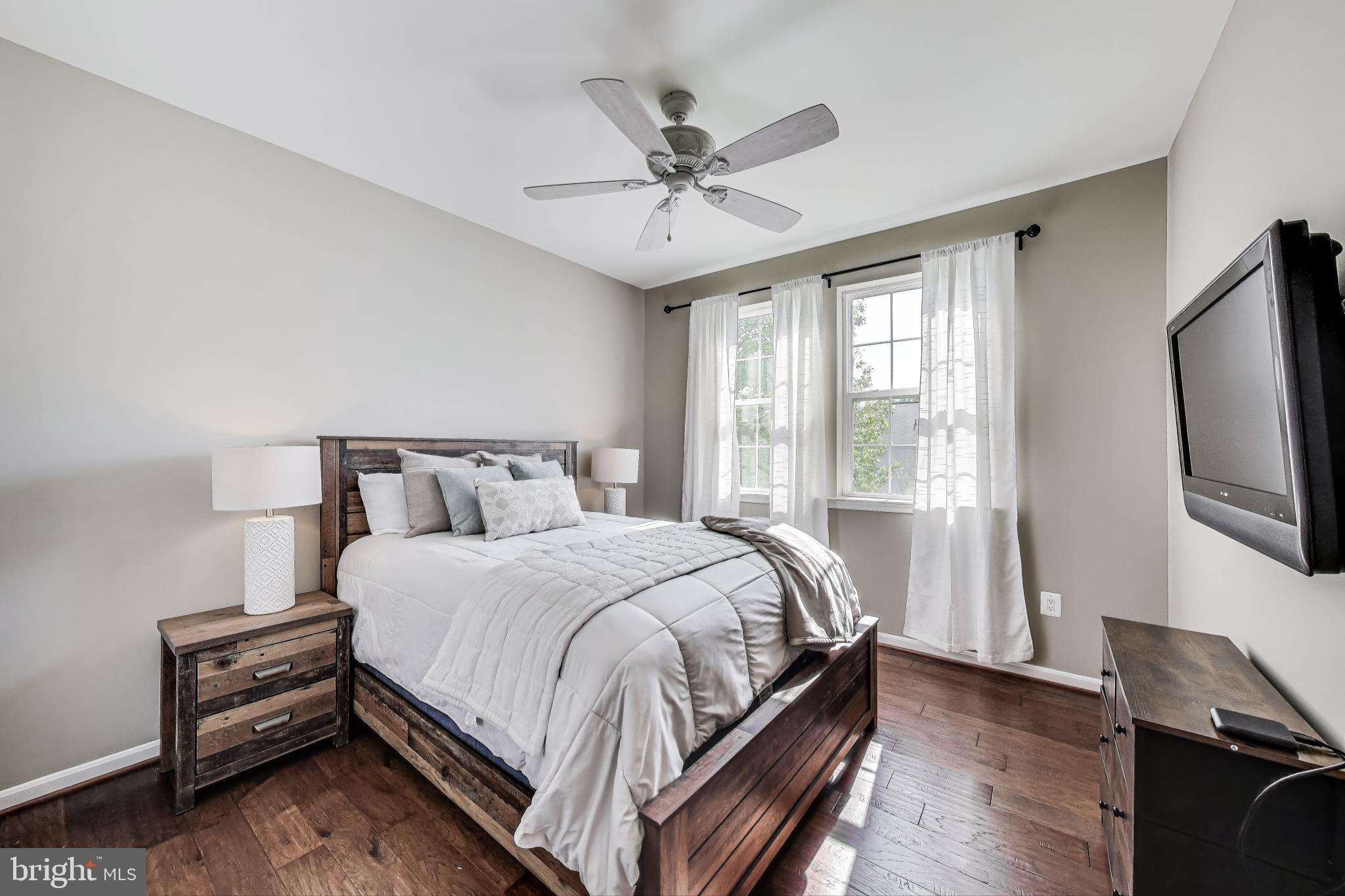 5701 Wink Way Woodbridge, VA 22193 - Photo 17 of 45 a bedroom with a bed and a chandelier