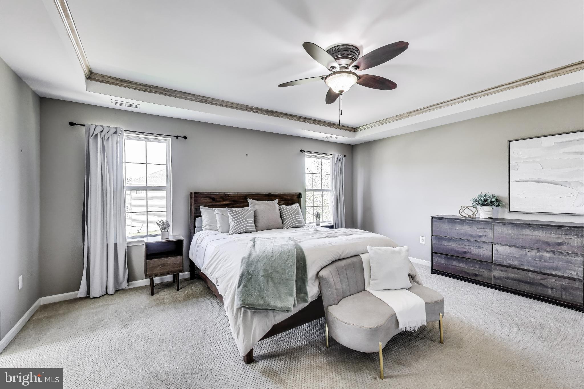 5701 Wink Way Woodbridge, VA 22193 - Photo 19 of 45 a bedroom with a bed and a chandelier