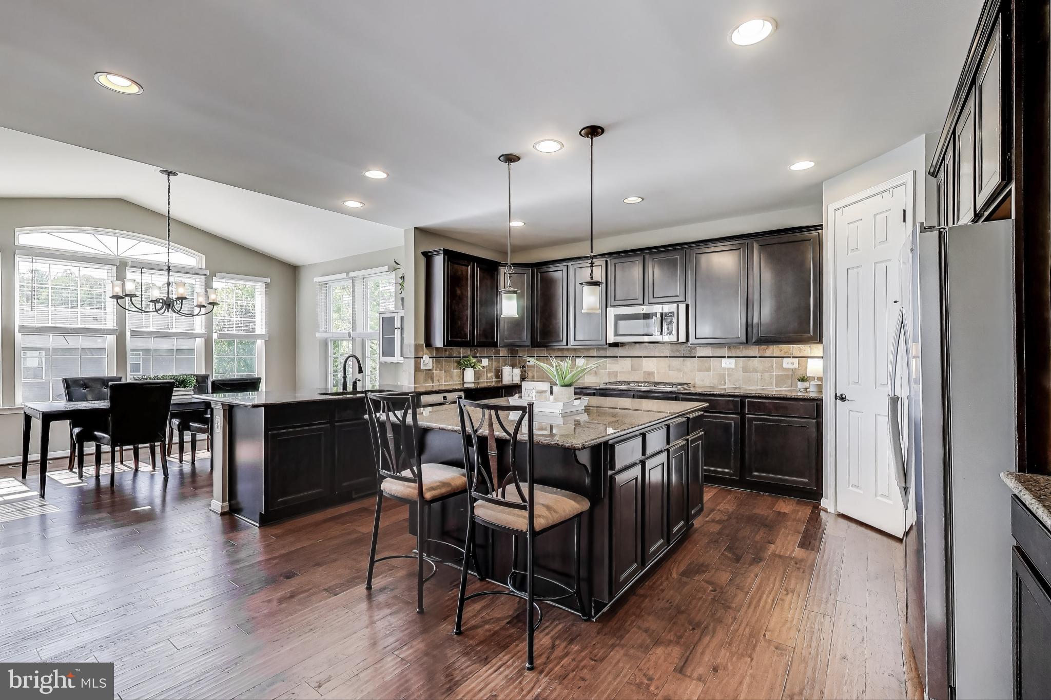 5701 Wink Way Woodbridge, VA 22193 - Photo 2 of 45 a kitchen with lots of counter space a sink appliances and dining table