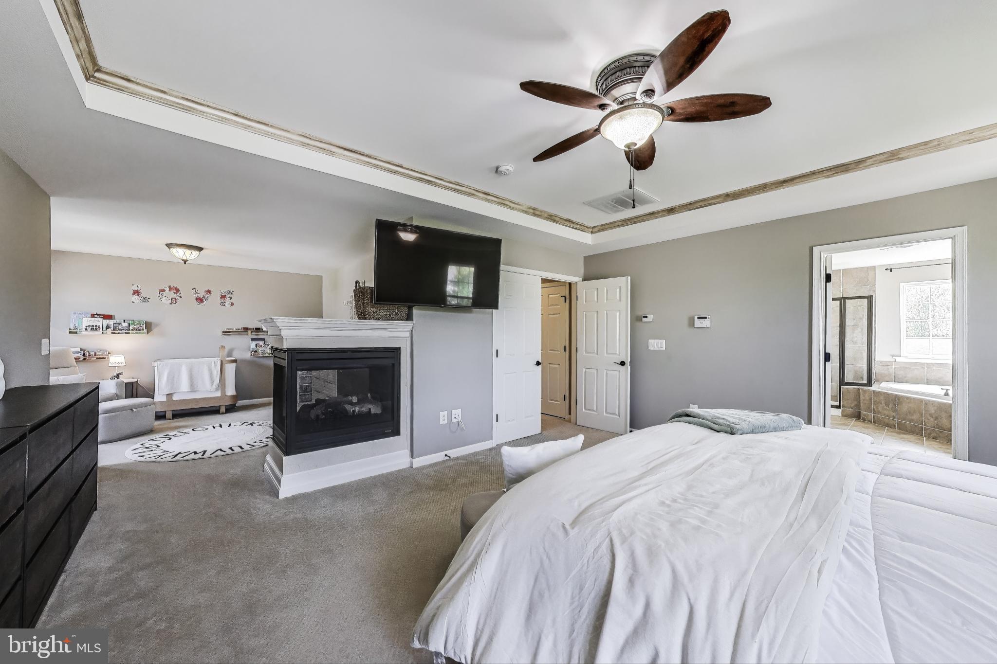5701 Wink Way Woodbridge, VA 22193 - Photo 21 of 45 a spacious bedroom with a bed and a fireplace