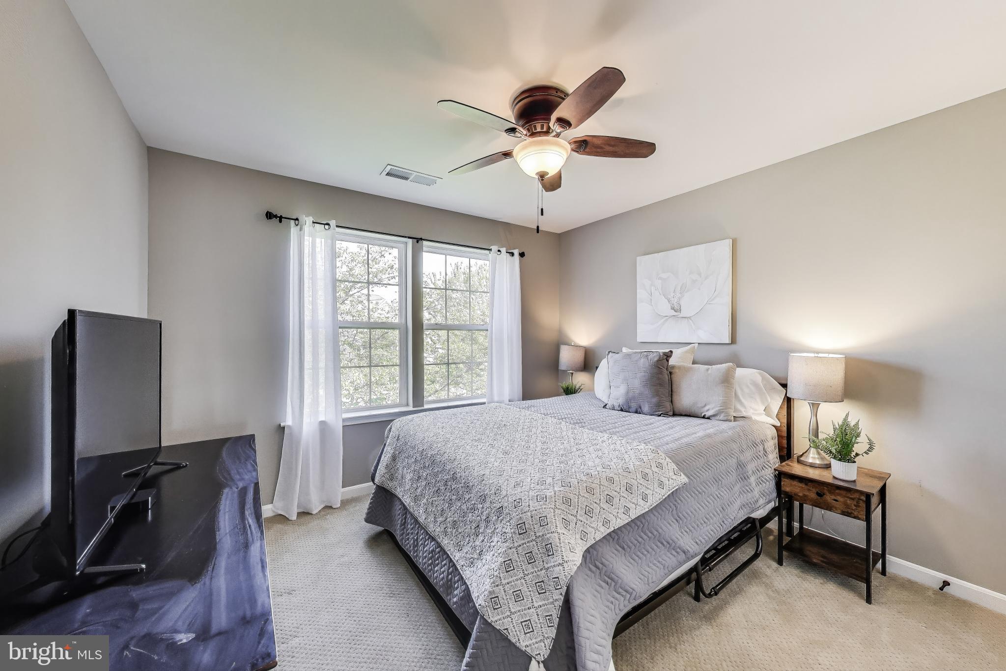 5701 Wink Way Woodbridge, VA 22193 - Photo 25 of 45 a bedroom with a bed tv and a window