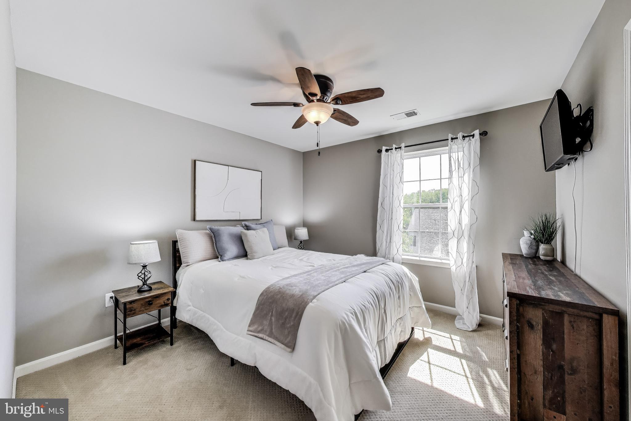 5701 Wink Way Woodbridge, VA 22193 - Photo 28 of 45 a bedroom with a bed flat screen tv and a window