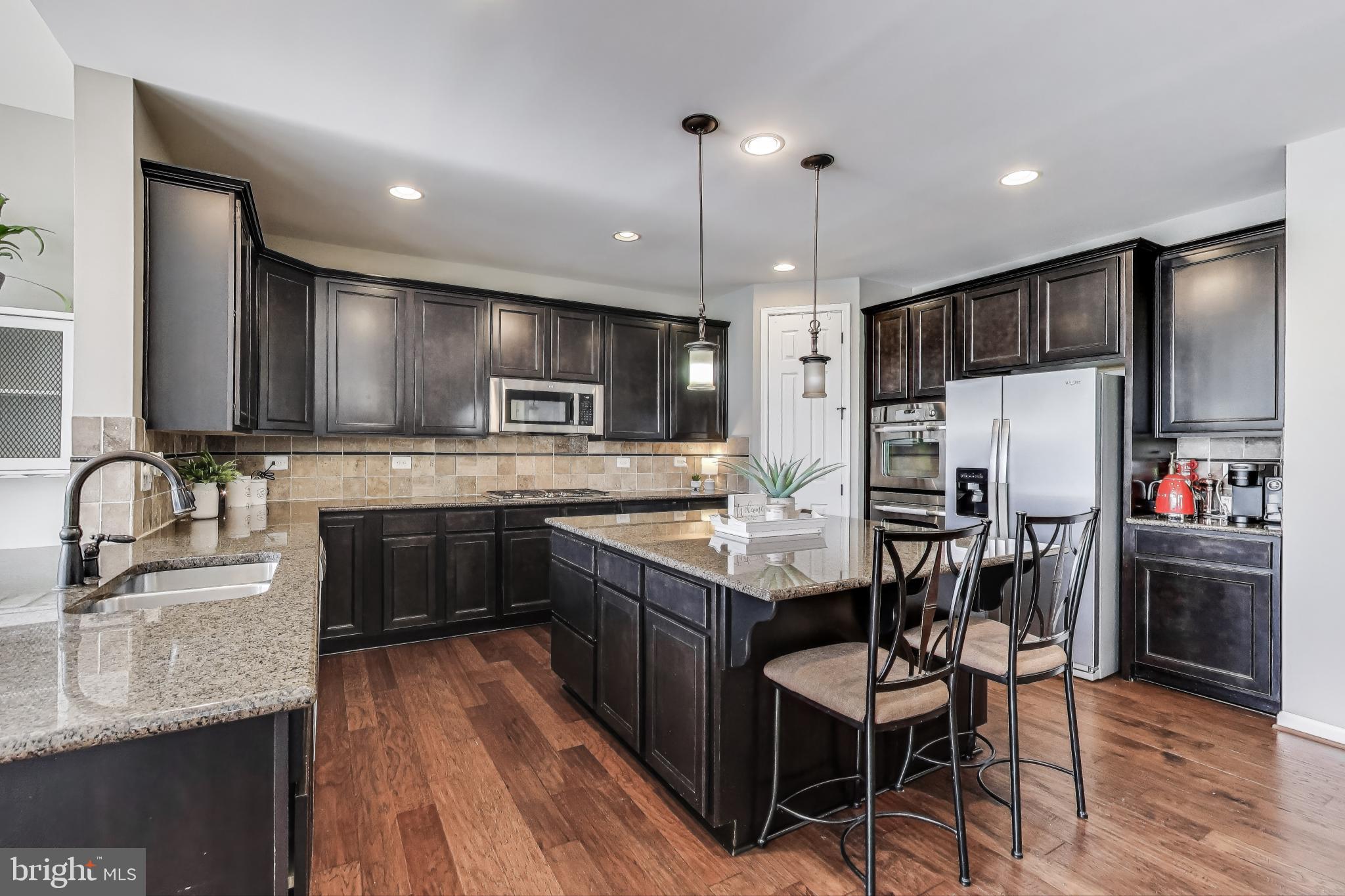 5701 Wink Way Woodbridge, VA 22193 - Photo 3 of 45 a kitchen with stainless steel appliances kitchen island granite countertop a sink refrigerator and cabinets