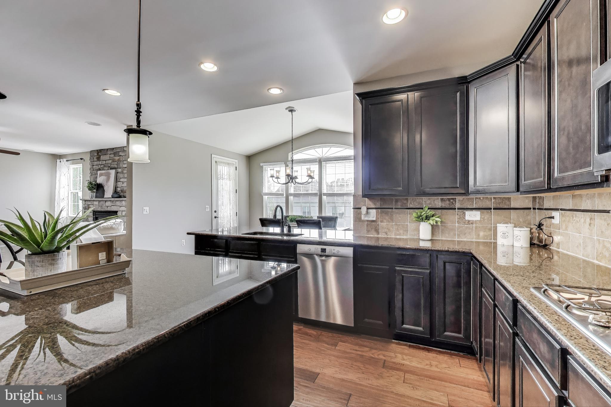 5701 Wink Way Woodbridge, VA 22193 - Photo 4 of 45 a kitchen with granite countertop a sink stove and refrigerator