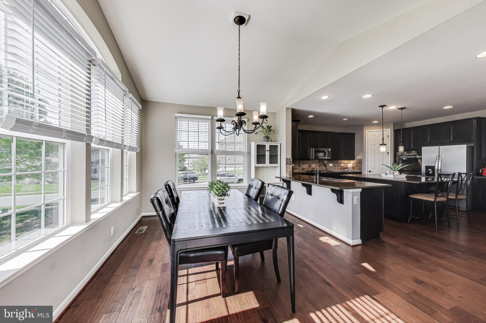 5701 Wink Way Woodbridge, VA 22193 - Photo 6 of 45 a view of a dining room and livingroom with furniture wooden floor a chandelier