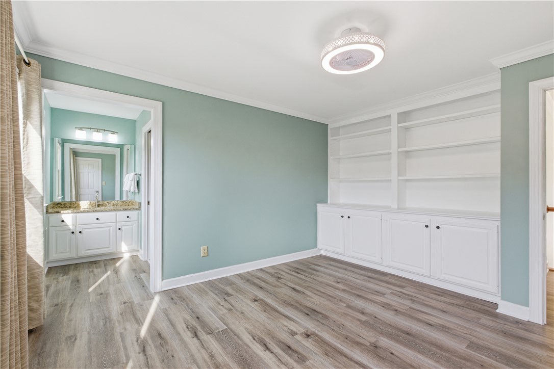 501 Capri Point Lavonia, GA 30553 - Photo 45 of 50 This versatile room features built-in shelving, durable flooring, and a ceiling fan, with an adjoining private bathroom.