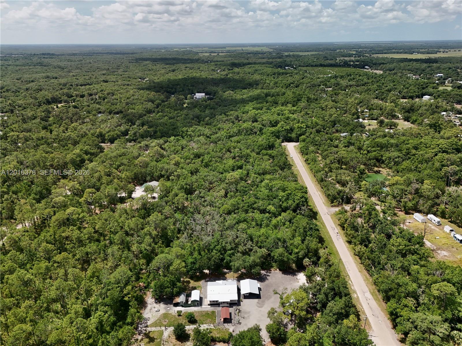 0 Southwest Gator Trail Arcadia, FL 34266 - Photo 16 of 21 an aerial view of residential houses with outdoor space and trees