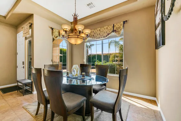 a dining room with furniture and a chandelier