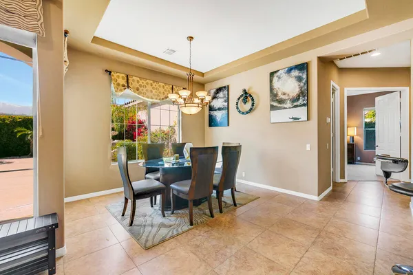 a view of a dining room with furniture and a window