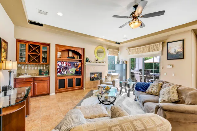 a living room with furniture and kitchen view
